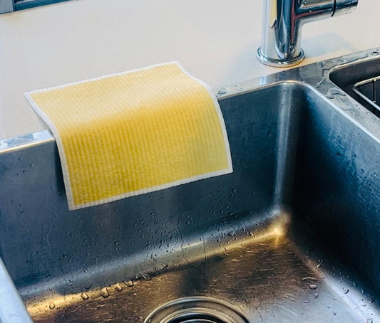 Reusable dish cloth drying on back of kitchen sink