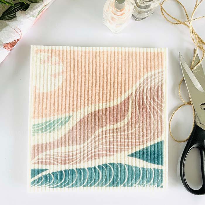 Zero waste sponge cloth with beach design on kitchen bench