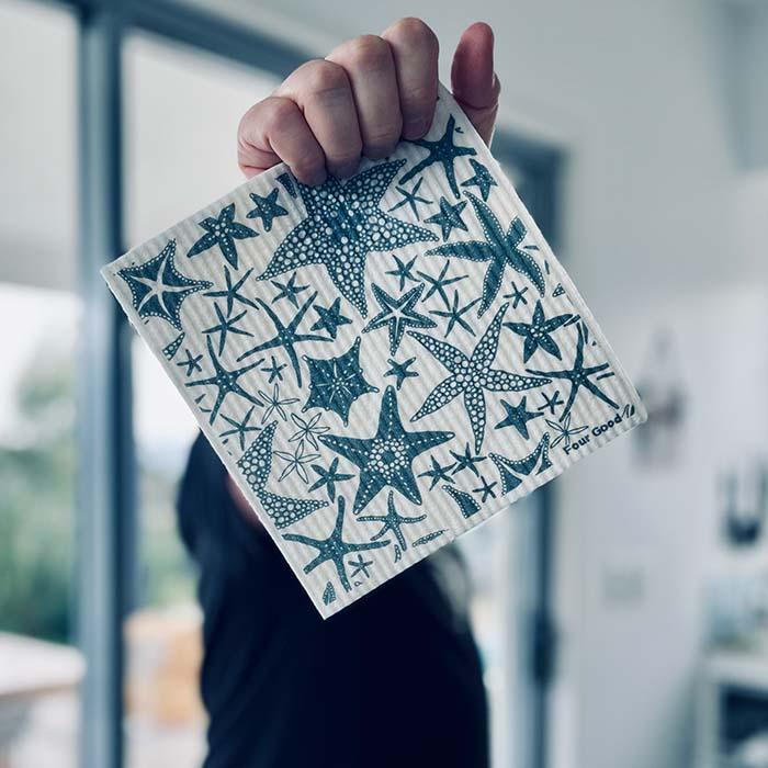 Hand holding a zero waste sponge cloth in kitchen